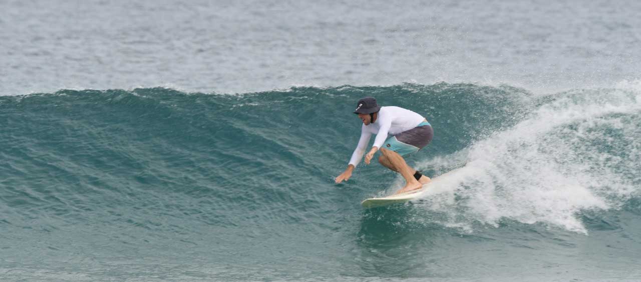 Surfing down the line at the Tamarindo beach break, Costa Rica