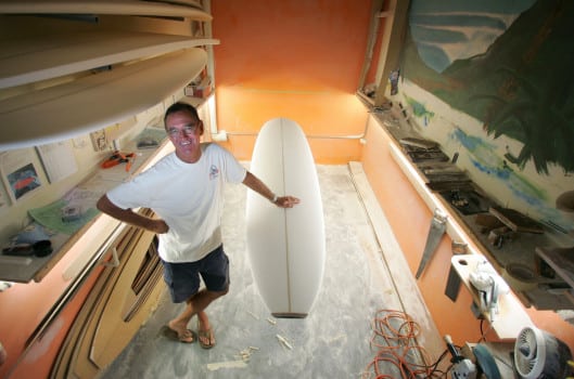 Robert August of Get Out and Surf with a surfboard at Witchs Rock Surf Camp.